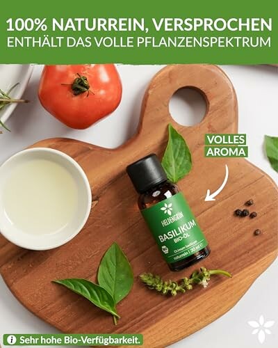 Basilikumöl mit Tomate und Blättern auf Holzbrett