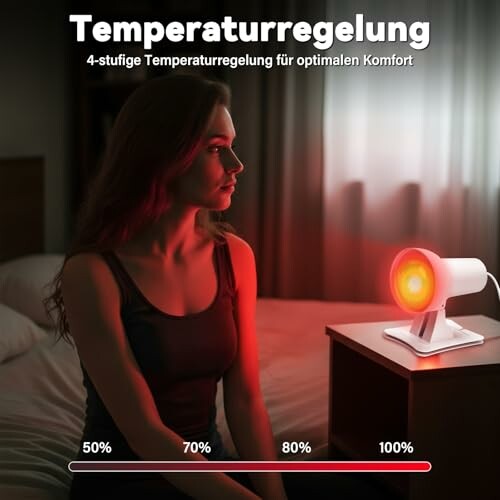 Frau sitzt im roten Licht eines Temperaturregelungsgeräts.